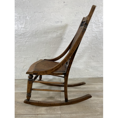 99 - An early 20th century beech rocking chair with embossed design