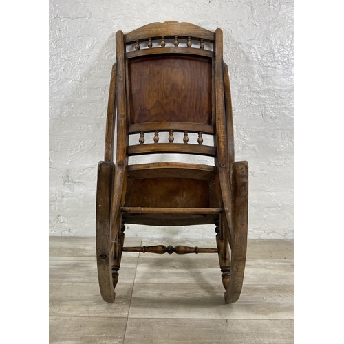 99 - An early 20th century beech rocking chair with embossed design