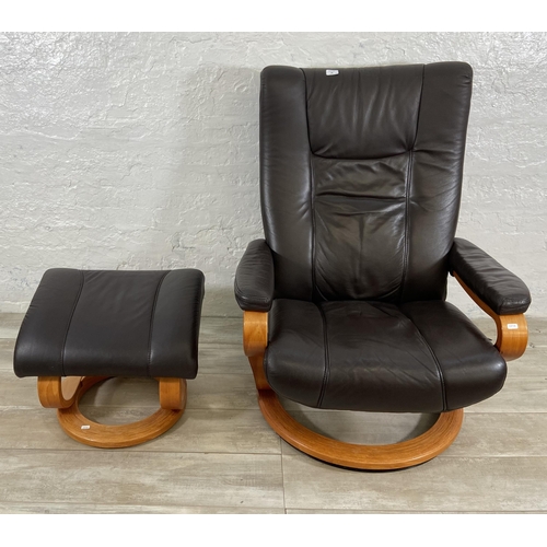 49 - A Himolla brown leather and bentwood swivel reclining armchair and footstool