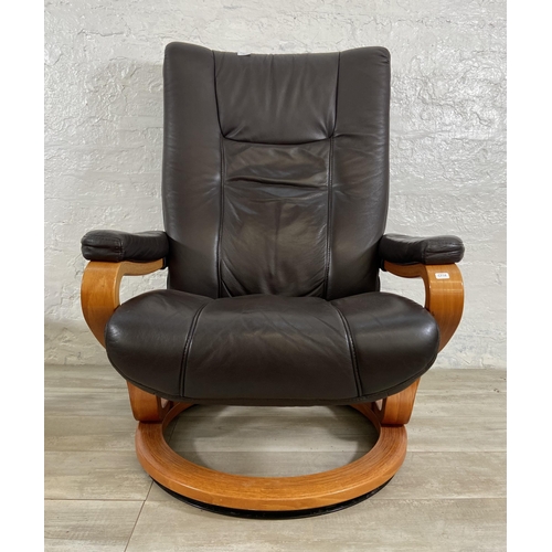 49 - A Himolla brown leather and bentwood swivel reclining armchair and footstool