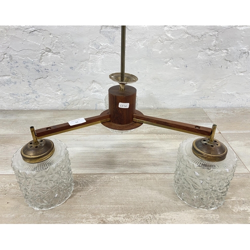 51 - A mid 20th century teak and brass three branch ceiling light fitting with glass shades - approx. 55c... 