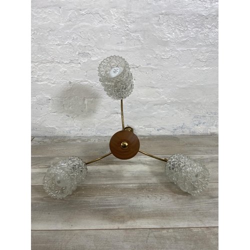 52 - A mid 20th century teak and brass three branch ceiling light fitting with glass shades - approx. 46c... 