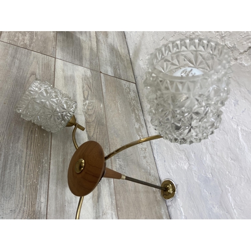 52 - A mid 20th century teak and brass three branch ceiling light fitting with glass shades - approx. 46c... 