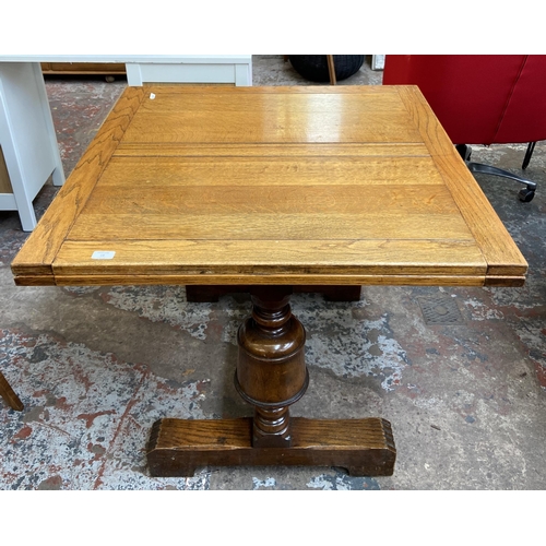 54 - A 1930s E. Gomme oak draw leaf dining table on baluster supports - approx. 74cm high x 92cm wide x 9... 