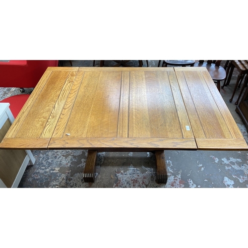 54 - A 1930s E. Gomme oak draw leaf dining table on baluster supports - approx. 74cm high x 92cm wide x 9... 