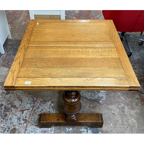 54 - A 1930s E. Gomme oak draw leaf dining table on baluster supports - approx. 74cm high x 92cm wide x 9... 