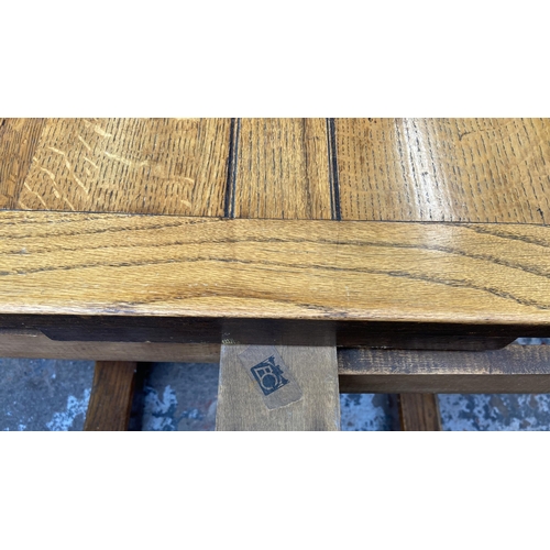 54 - A 1930s E. Gomme oak draw leaf dining table on baluster supports - approx. 74cm high x 92cm wide x 9... 