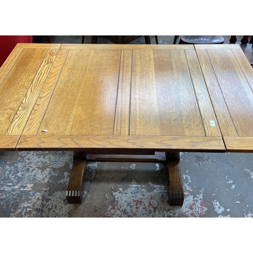 54 - A 1930s E. Gomme oak draw leaf dining table on baluster supports - approx. 74cm high x 92cm wide x 9... 