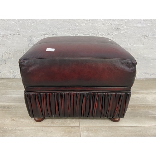 57 - An oxblood leather storage footstool - approx. 44cm high x 56cm wide x 42cm deep