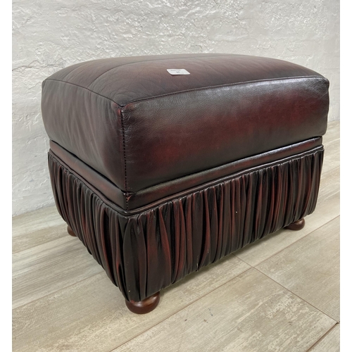 57 - An oxblood leather storage footstool - approx. 44cm high x 56cm wide x 42cm deep