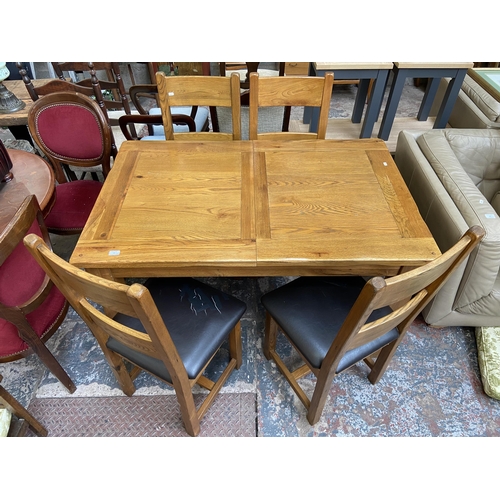 59 - A modern solid oak extending dining table and four chairs - approx. 79cm high x 90cm wide x 140cm lo... 