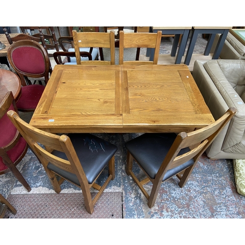 59 - A modern solid oak extending dining table and four chairs - approx. 79cm high x 90cm wide x 140cm lo... 