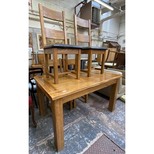 59 - A modern solid oak extending dining table and four chairs - approx. 79cm high x 90cm wide x 140cm lo... 