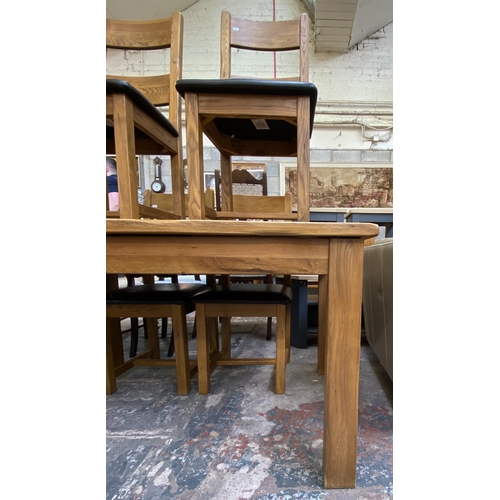 59 - A modern solid oak extending dining table and four chairs - approx. 79cm high x 90cm wide x 140cm lo... 