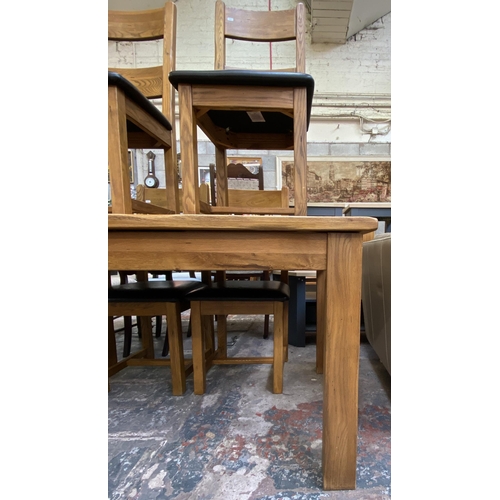 59 - A modern solid oak extending dining table and four chairs - approx. 79cm high x 90cm wide x 140cm lo... 