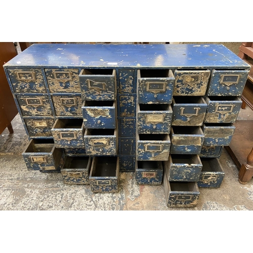 108 - A mid 20th century industrial blue painted wooden bank of drawers - approx. 60cm high x 94cm wide x ... 