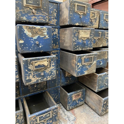 108 - A mid 20th century industrial blue painted wooden bank of drawers - approx. 60cm high x 94cm wide x ... 