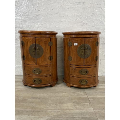 114 - A pair of Chinese camphor wood and brass cylindrical bedside cabinets - approx. 62cm high x 44cm wid... 