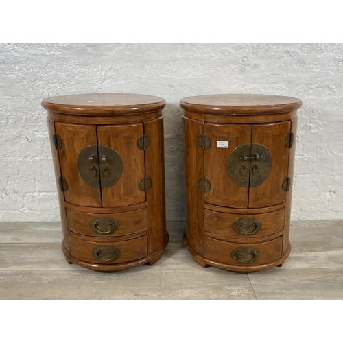 114 - A pair of Chinese camphor wood and brass cylindrical bedside cabinets - approx. 62cm high x 44cm wid... 