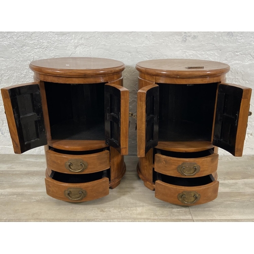 114 - A pair of Chinese camphor wood and brass cylindrical bedside cabinets - approx. 62cm high x 44cm wid... 