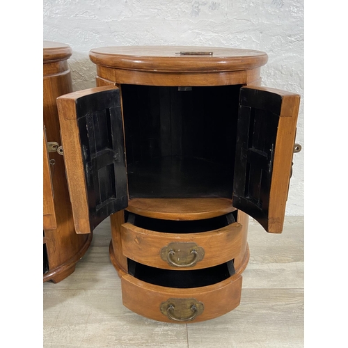 114 - A pair of Chinese camphor wood and brass cylindrical bedside cabinets - approx. 62cm high x 44cm wid... 