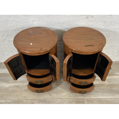 114 - A pair of Chinese camphor wood and brass cylindrical bedside cabinets - approx. 62cm high x 44cm wid... 