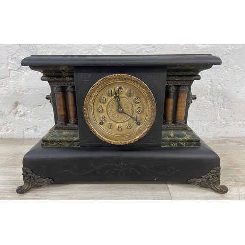 116 - A 19th century ebonised eight day mantel clock on cast metal supports - approx. 29cm high x 45cm wid... 