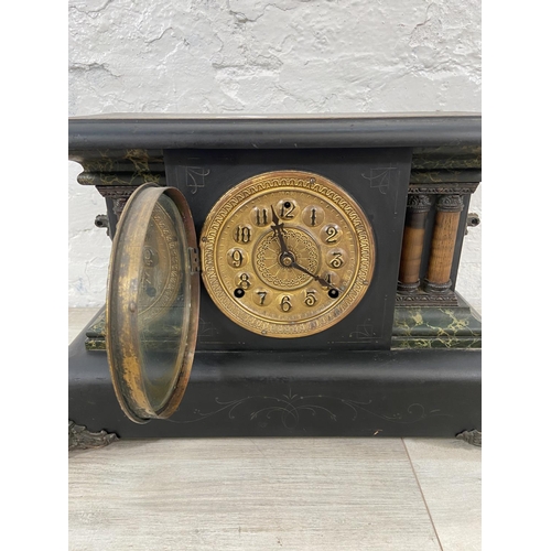 116 - A 19th century ebonised eight day mantel clock on cast metal supports - approx. 29cm high x 45cm wid... 