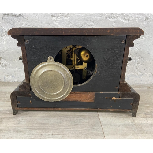 116 - A 19th century ebonised eight day mantel clock on cast metal supports - approx. 29cm high x 45cm wid... 