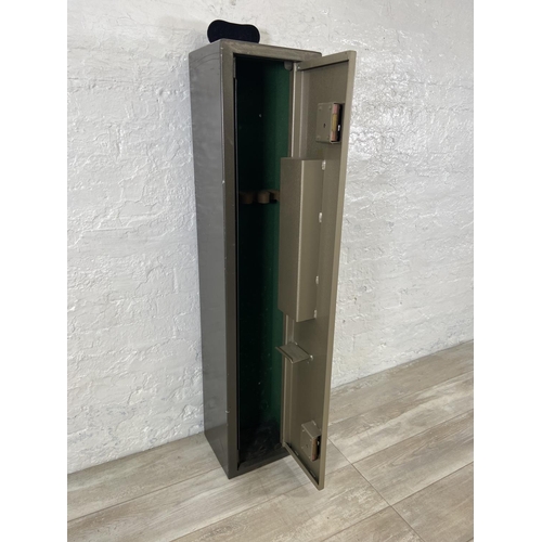 120 - A metal gun cabinet - approx. 132cm high x 29cm wide x 24cm deep (key in office)