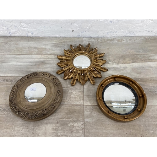 140 - Three mid 20th century framed convex wall mirrors to include sunburst, porthole etc. - largest appro... 