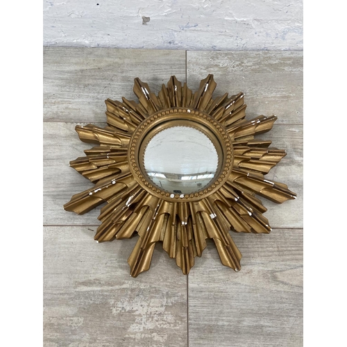 140 - Three mid 20th century framed convex wall mirrors to include sunburst, porthole etc. - largest appro... 