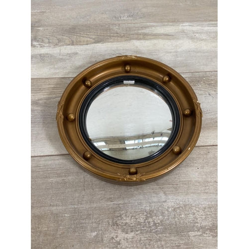 140 - Three mid 20th century framed convex wall mirrors to include sunburst, porthole etc. - largest appro... 