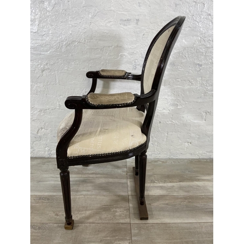 145 - A French Louis XVI style stained hardwood and fabric upholstered open armchair