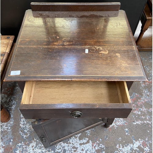 148 - An early 20th century oak bedside cabinet - approx. 80cm high x 60cm wide x 50cm deep