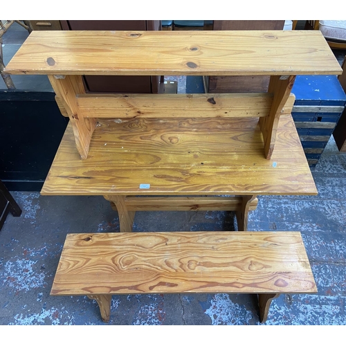 150 - A pine dining table and two benches - approx. 75cm high x 55cm wide x 106cm long