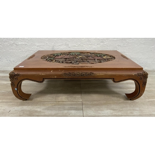 151 - A Chinese carved hardwood and hand painted coffee table - approx. 35cm high x 80cm wide x 120cm long