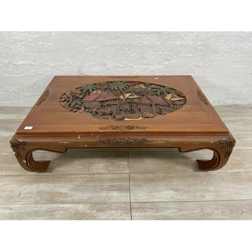 151 - A Chinese carved hardwood and hand painted coffee table - approx. 35cm high x 80cm wide x 120cm long