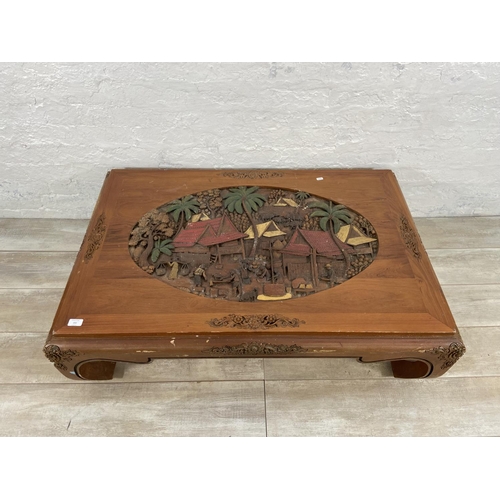 151 - A Chinese carved hardwood and hand painted coffee table - approx. 35cm high x 80cm wide x 120cm long