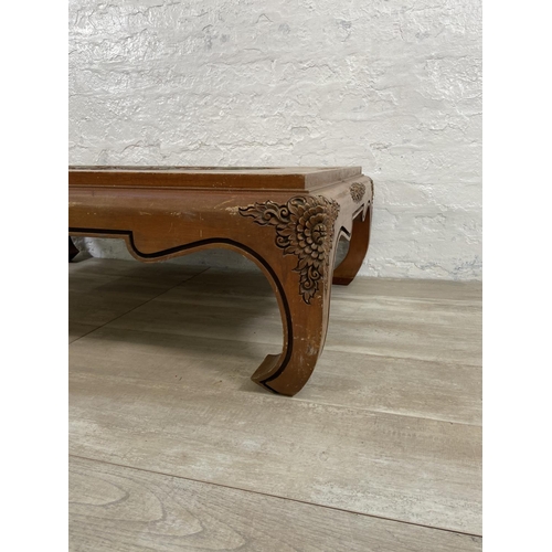 151 - A Chinese carved hardwood and hand painted coffee table - approx. 35cm high x 80cm wide x 120cm long