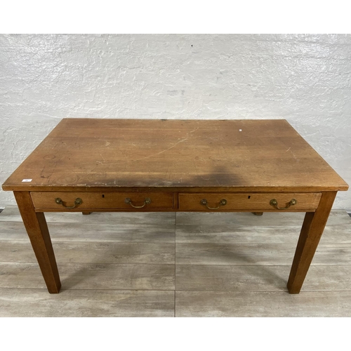 152 - An early/mid 20th century oak two drawer writing desk - approx. 79cm high x 152cm wide x 84cm deep