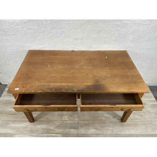 152 - An early/mid 20th century oak two drawer writing desk - approx. 79cm high x 152cm wide x 84cm deep