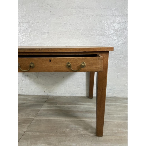 152 - An early/mid 20th century oak two drawer writing desk - approx. 79cm high x 152cm wide x 84cm deep