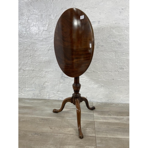 156 - A Georgian mahogany circular tilt top tripod occasional table - approx. 102cm high when tilted x 55c... 