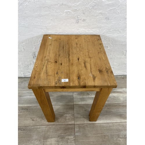 165 - A modern oak side table - approx. 62cm high x 55cm wide x 50cm deep