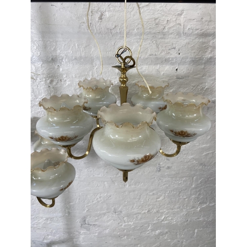 186 - A pair of brass five branch chandeliers with floral design opaque glass shades