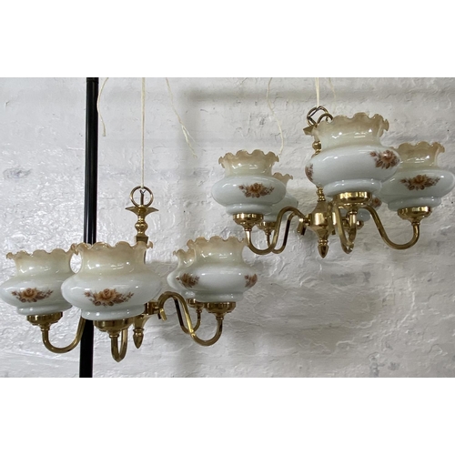 186 - A pair of brass five branch chandeliers with floral design opaque glass shades