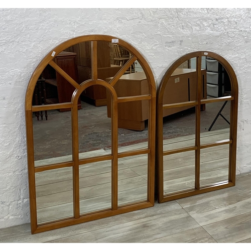 189 - Two teak panelled framed arched wall mirrors - largest approx. 105cm high x 73cm wide