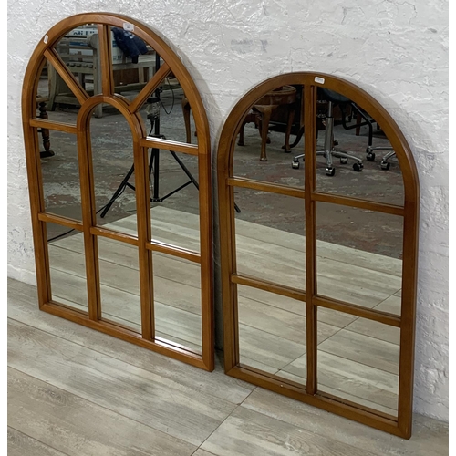 189 - Two teak panelled framed arched wall mirrors - largest approx. 105cm high x 73cm wide