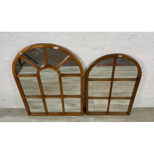 189 - Two teak panelled framed arched wall mirrors - largest approx. 105cm high x 73cm wide